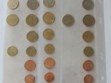 a lot of coins in a plastic bag on a table
