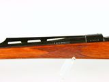 a close up of a rifle on a white background with a marker