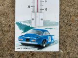 a thermometer with a picture of a blue car on it