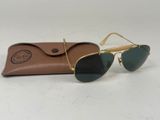 a pair of sunglasses sitting on top of a brown case