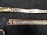 two old tools that are laying on a black surface