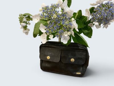 a black purse with a bunch of flowers in it