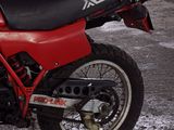 a red and black motorcycle parked in a garage