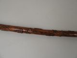 an old wooden baseball bat with writing on it on a white surface