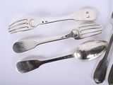 a lot of silver spoons and forks on the table