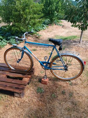 a blue bike that is parked on a wooden pallet