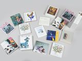 many cards laid out on a table with a cup of coffee