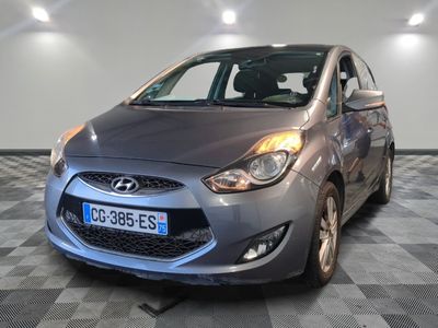 a picture of a car that is parked in a showroom