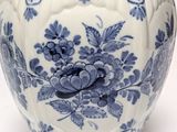 a blue and white vase with a bird on it