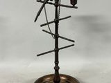 a metal bird on a stand with a chain around it