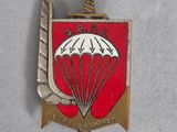 an image of a red and white badge with a parachute on it