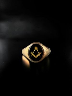 a close up of a ring with a masonic symbol on it
