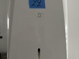 a paper towel dispenser with a blue sticker on it