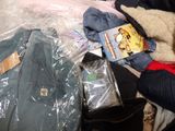 a pile of clothes and other items on a bed
