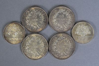 six different coins are arranged in a circle on a gray surface