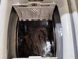 a white washer with a black bag inside of it