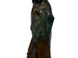 bronze statue of a woman with a veil on her head and a cloak over her head