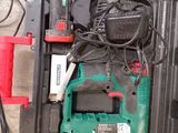 a green and black tool box with tools in it