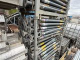 a large pile of steel pipes stacked on top of each other