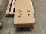 a large cardboard box sitting on a pallet in a warehouse