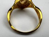 an image of a gold ring with a stone in the middle
