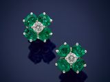 a pair of emerald and diamond earrings