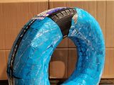 a blue inflatable tube sitting on the floor in front of a cardboard box