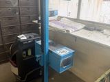 a blue machine that is sitting in the corner of a room