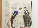 an open book with a picture of two women in dresses