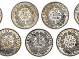 six different types of coins are shown on a white surface