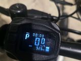 a digital clock on the handlebar of a bike