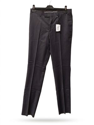 the black pants are hanging on a hanger on a white wall