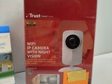 a box with a camera on it next to a package of post - it notes