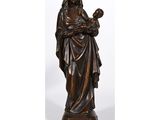 a bronze statue of a woman holding a child