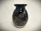 a black and white vase sitting on a white surface