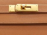 a close up of a brown leather purse with gold hardware