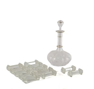 a glass decanter and a set of pieces of glass