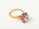 a close up of a gold ring with an amethorate stone