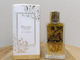 an image of a bottle of perfume sitting next to a box on a table