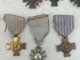 many medals and medals on display on a white surface