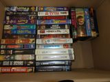 a lot of games in a cardboard box on the floor