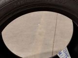 a tire with a sticker on it sitting on the ground