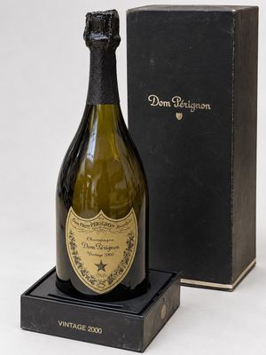 an old bottle of champagne in a black box with a black lid