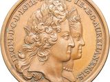 une image représentant une pièce d'or sur laquelle figurent la tête d'une femme et un papillon