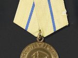 a gold medal with a blue and white ribbon around it