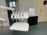 a room with a chair, a table, and a radio
