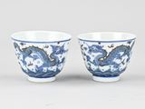 pair of blue and white cups with dragon design