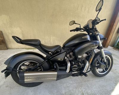 a black motorcycle parked in front of a building