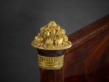 a gold decoration on the headboard of a bed