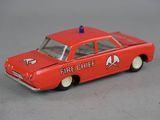 a red toy car with a fire chief on top of it